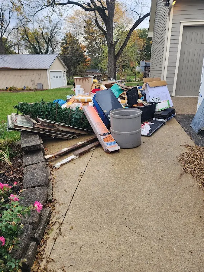 Dumpster being loaded with debris for 12 Yard Dumpster Rental in Sharon